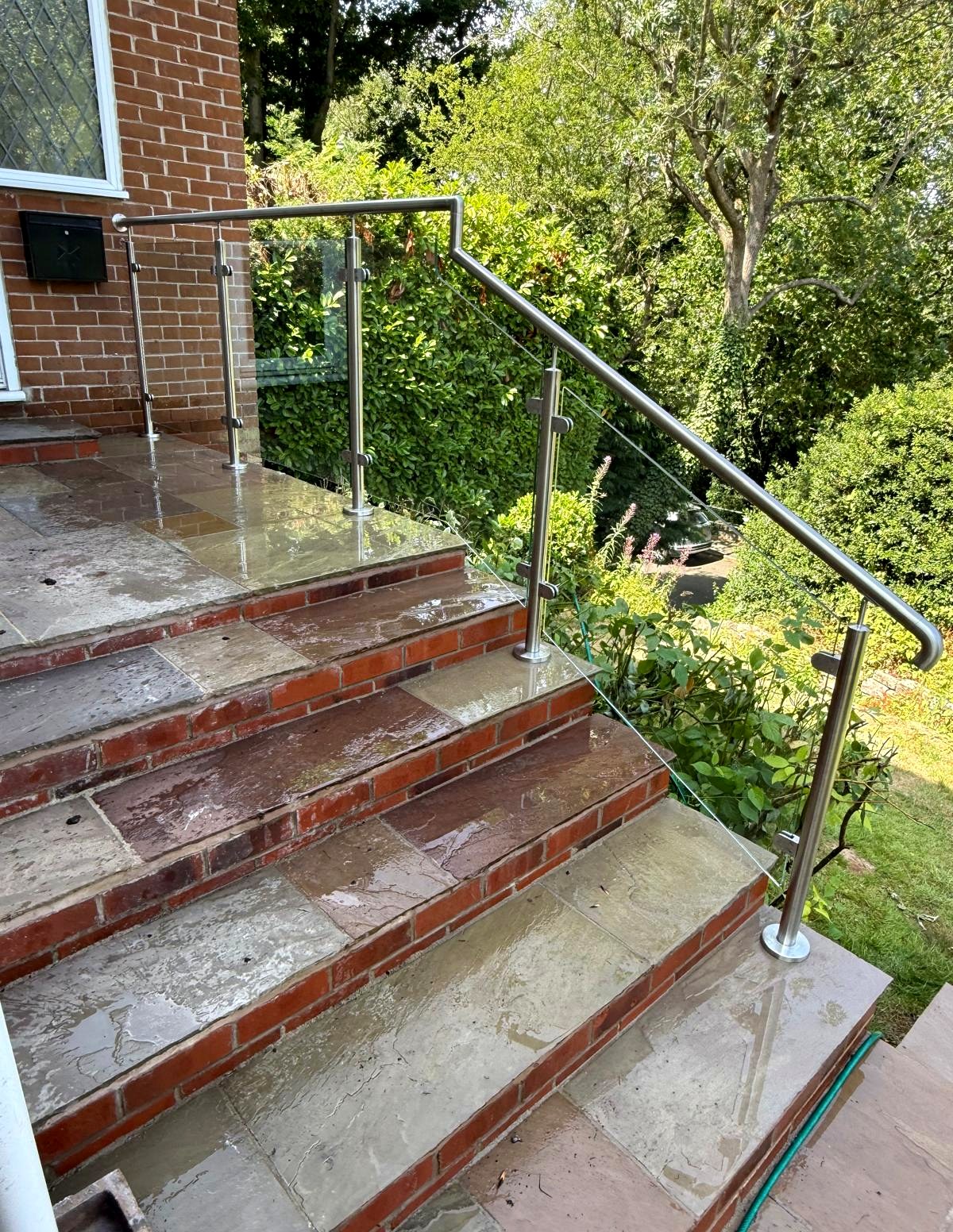 Stainless steel and glass balustrade to external steps looking down towards the garden, Sheffield